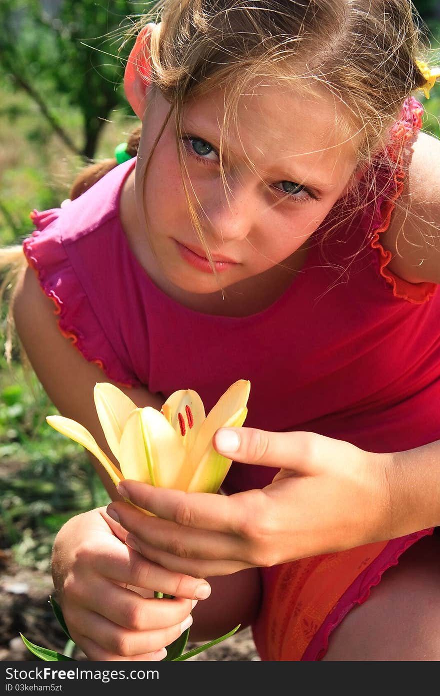 portrait of the grief young girl with yellow lily