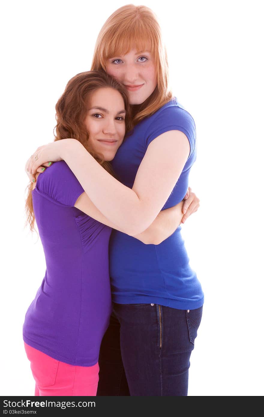 Two young girls wrapped thightly in front of the camera. Two young girls wrapped thightly in front of the camera