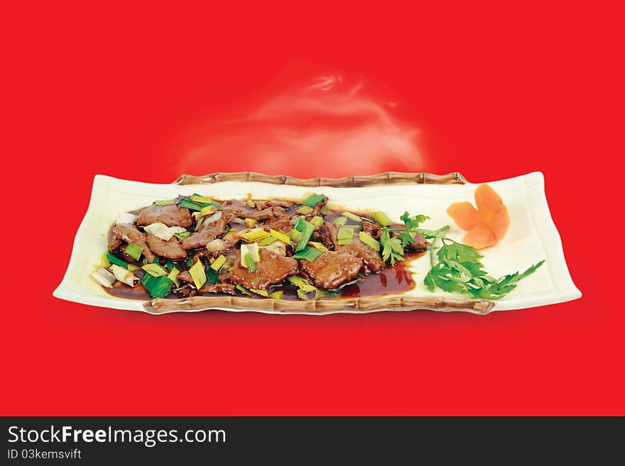 Chinese cuisine. Beef with Spring Onions on red background. Chinese cuisine. Beef with Spring Onions on red background.