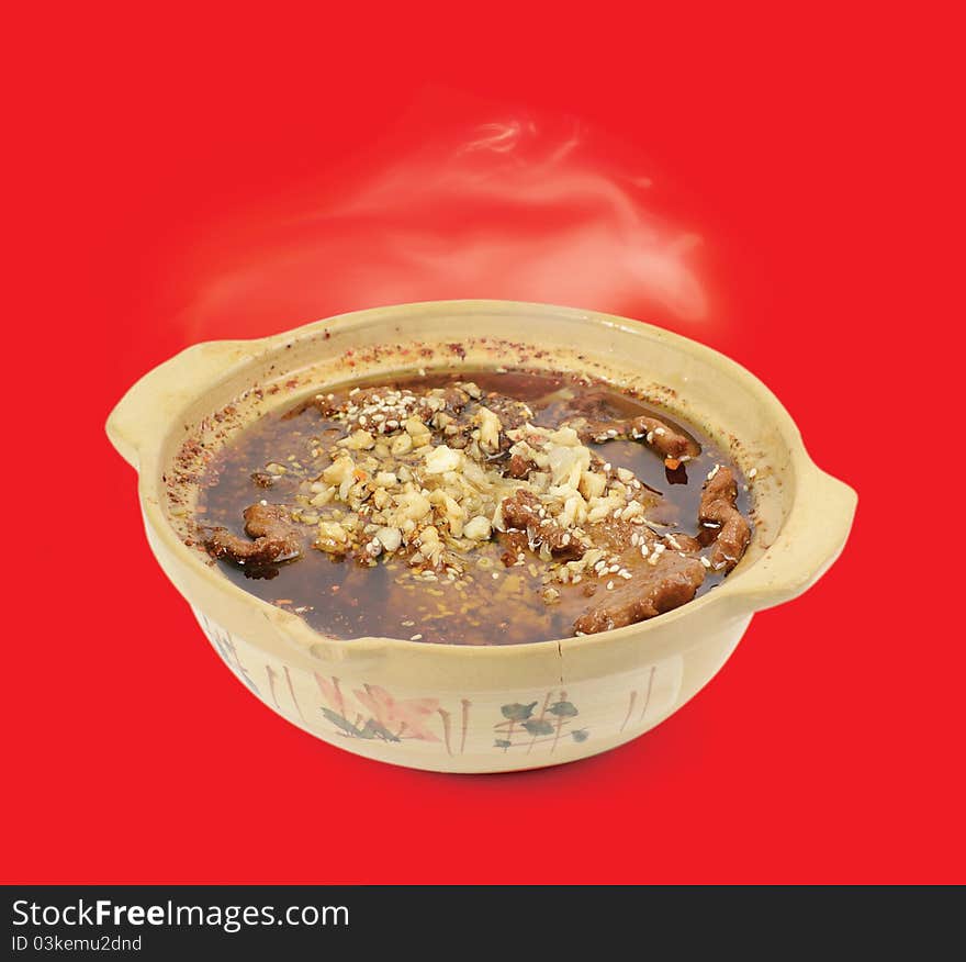 Chinese cuisine. Beef hot pot on a red background. Chinese cuisine. Beef hot pot on a red background.