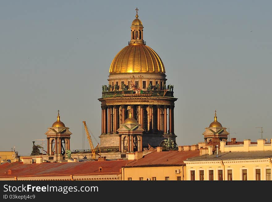 Sankt Petersburg landmark Isaac cathedral withneighbouring houses on a bright sunny day. Sankt Petersburg landmark Isaac cathedral withneighbouring houses on a bright sunny day