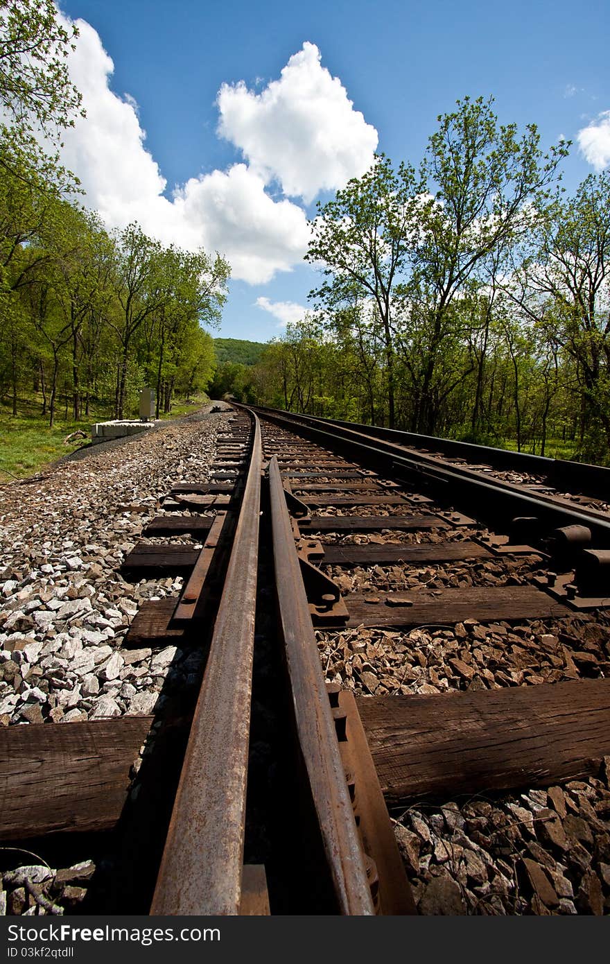 Railroad tracks running through a country setting. Railroad tracks running through a country setting