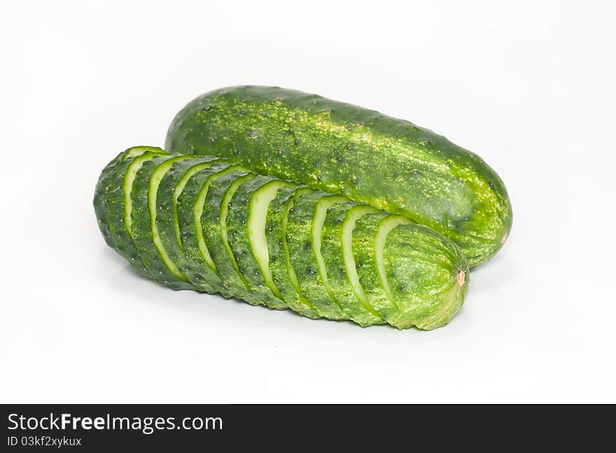 Cut and whole green cucumbers