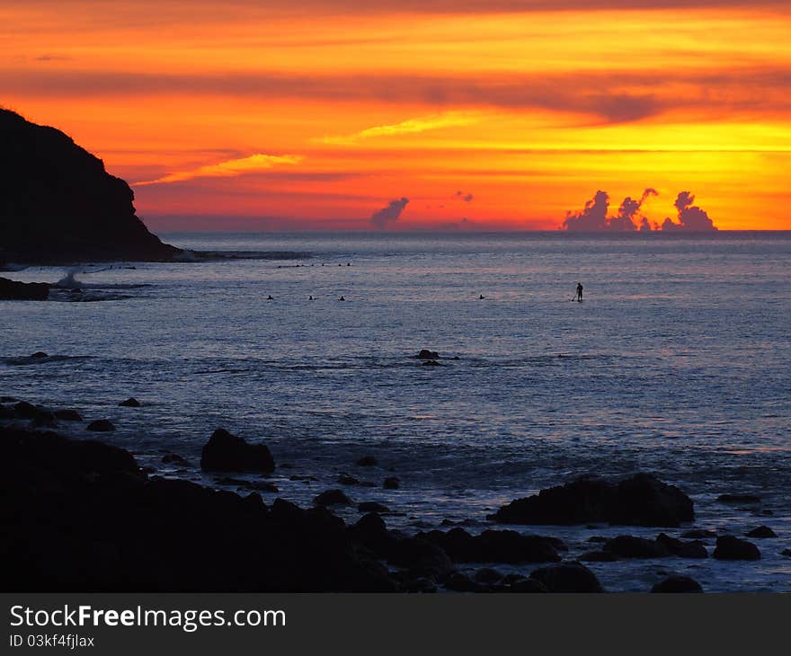 Orange and yellow sunset over rocky outcrops. Orange and yellow sunset over rocky outcrops