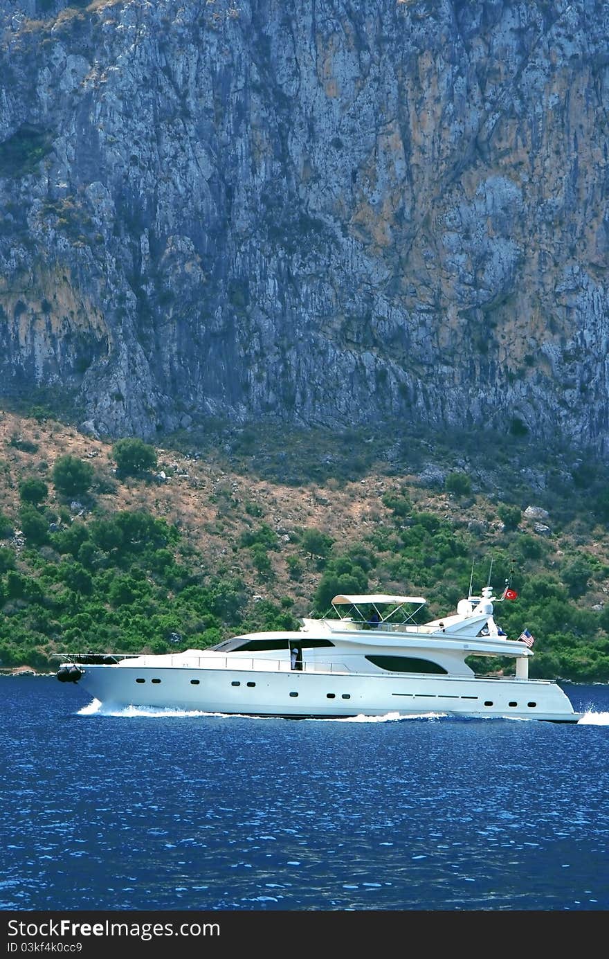 Motorboat (yacht) at sea on a background mountains. Motorboat (yacht) at sea on a background mountains