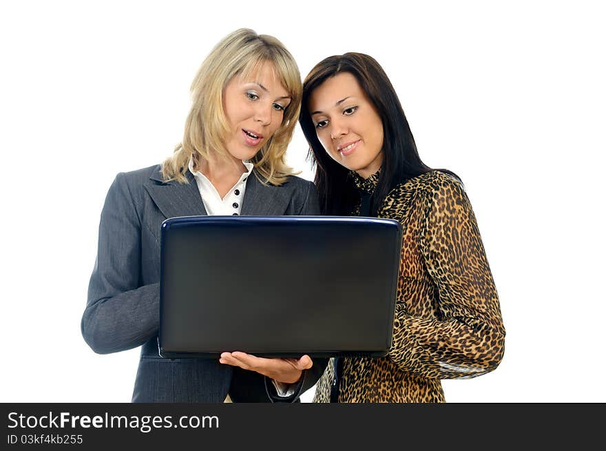 Two young business women with a laptop