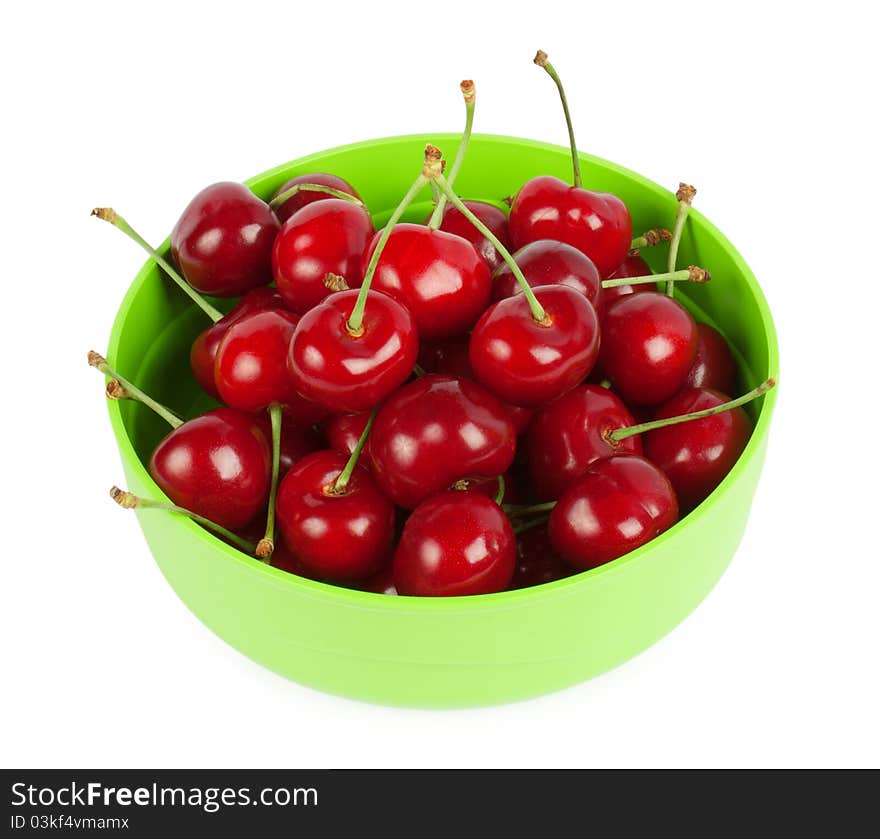 Red cherries on a plate isolated on white