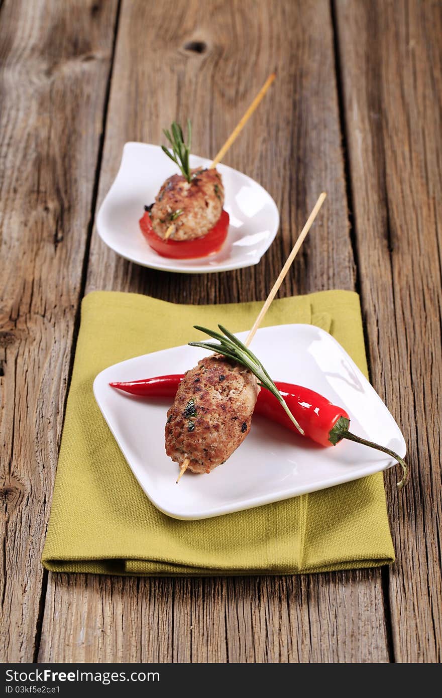 Minced meat kebabs on wooden skewers - still life