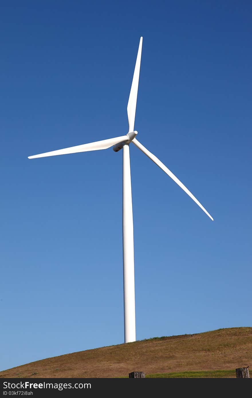 A wind turbine on top of a hill in Washington state. A wind turbine on top of a hill in Washington state.