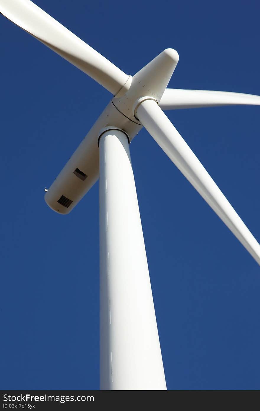 Wind turbine turning its blades in the wind. Wind turbine turning its blades in the wind.