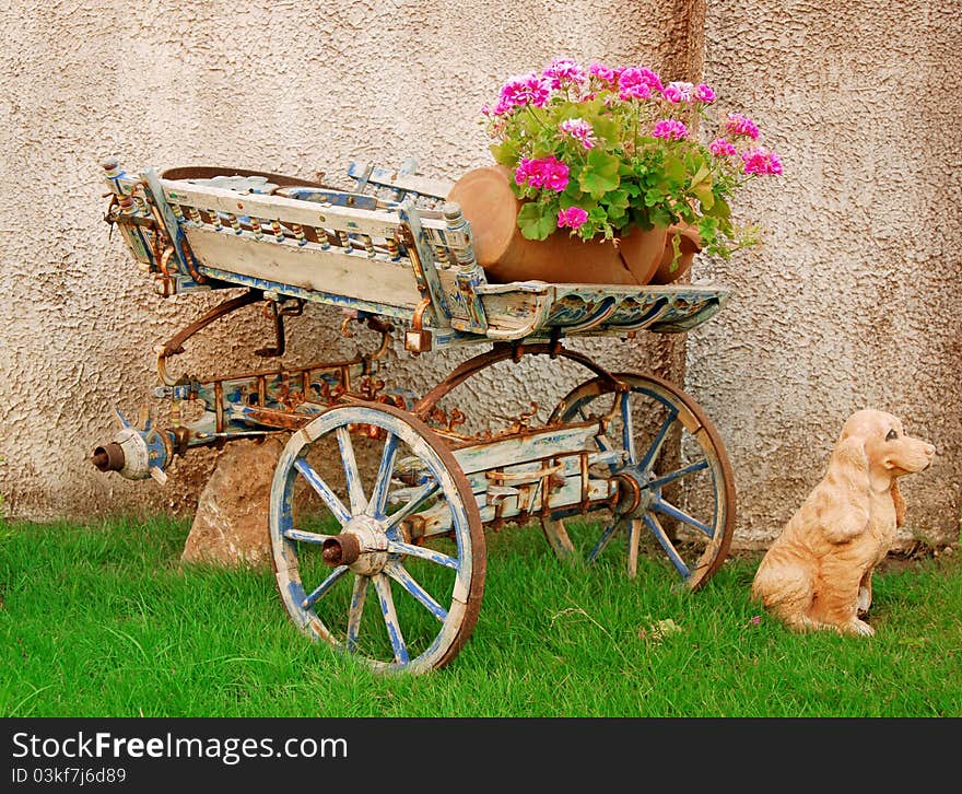 Flowers in flowerpot on old cart