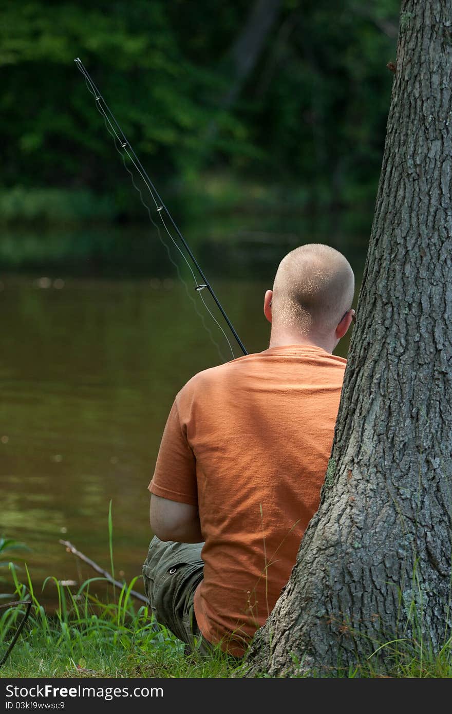 Young man relaxing and fishing on a lake in Virginia. Young man relaxing and fishing on a lake in Virginia.