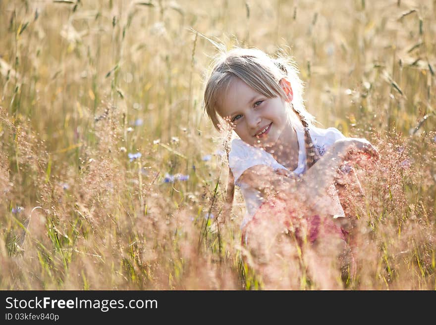 Blond hair girl in a meadow, surraunded by grain. Blond hair girl in a meadow, surraunded by grain.