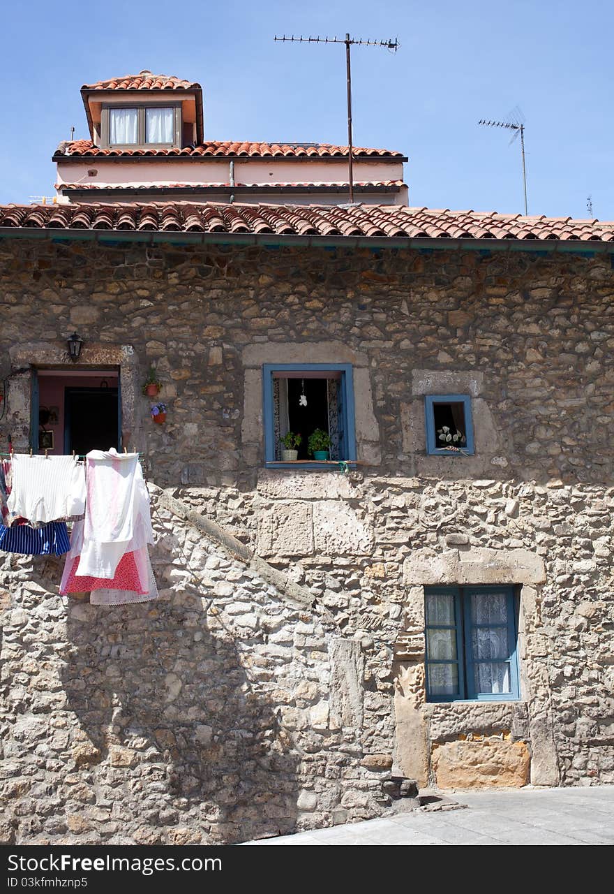 White laundry hanging to dry in a stone house