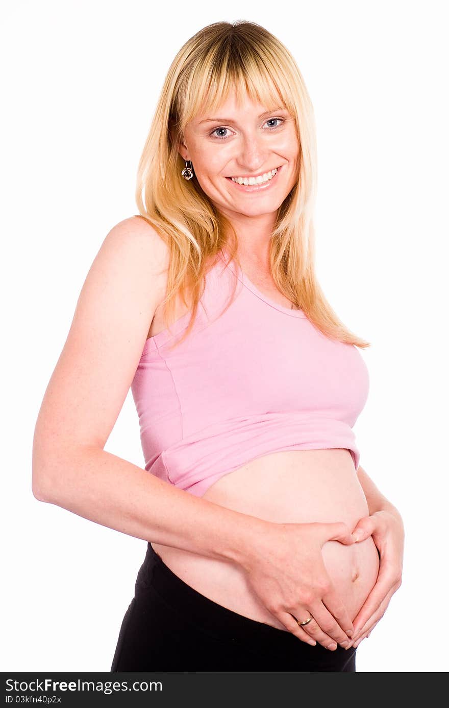 Beautiful pregnant woman standing on a white. Beautiful pregnant woman standing on a white