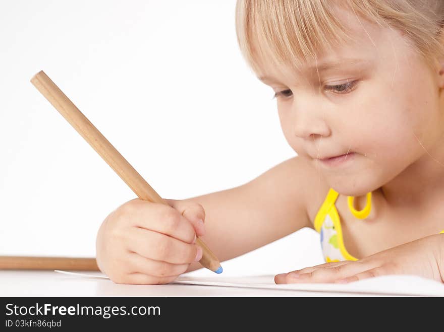 Little girl draws on a white background