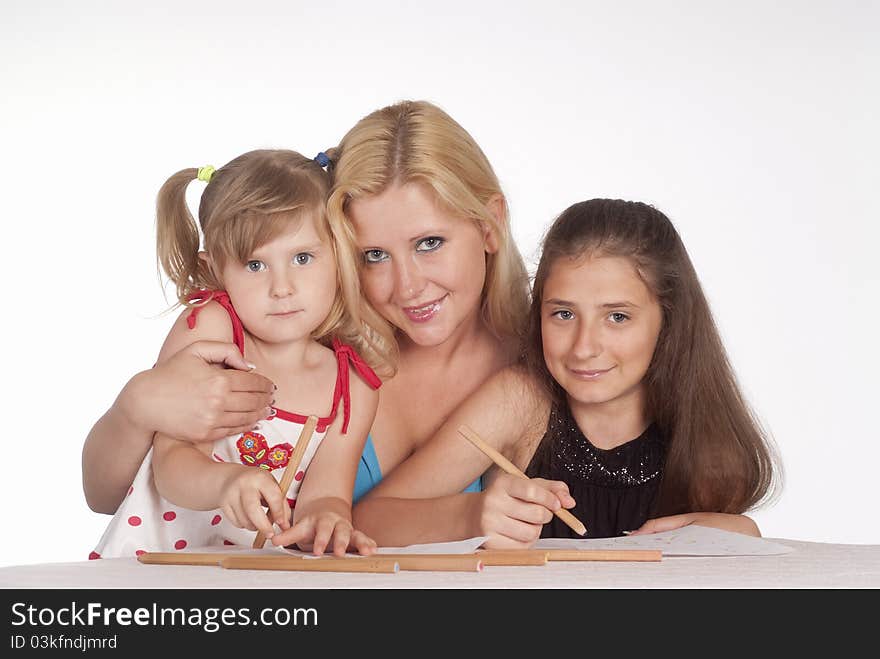 Portrait of a three girls drawing on a white. Portrait of a three girls drawing on a white