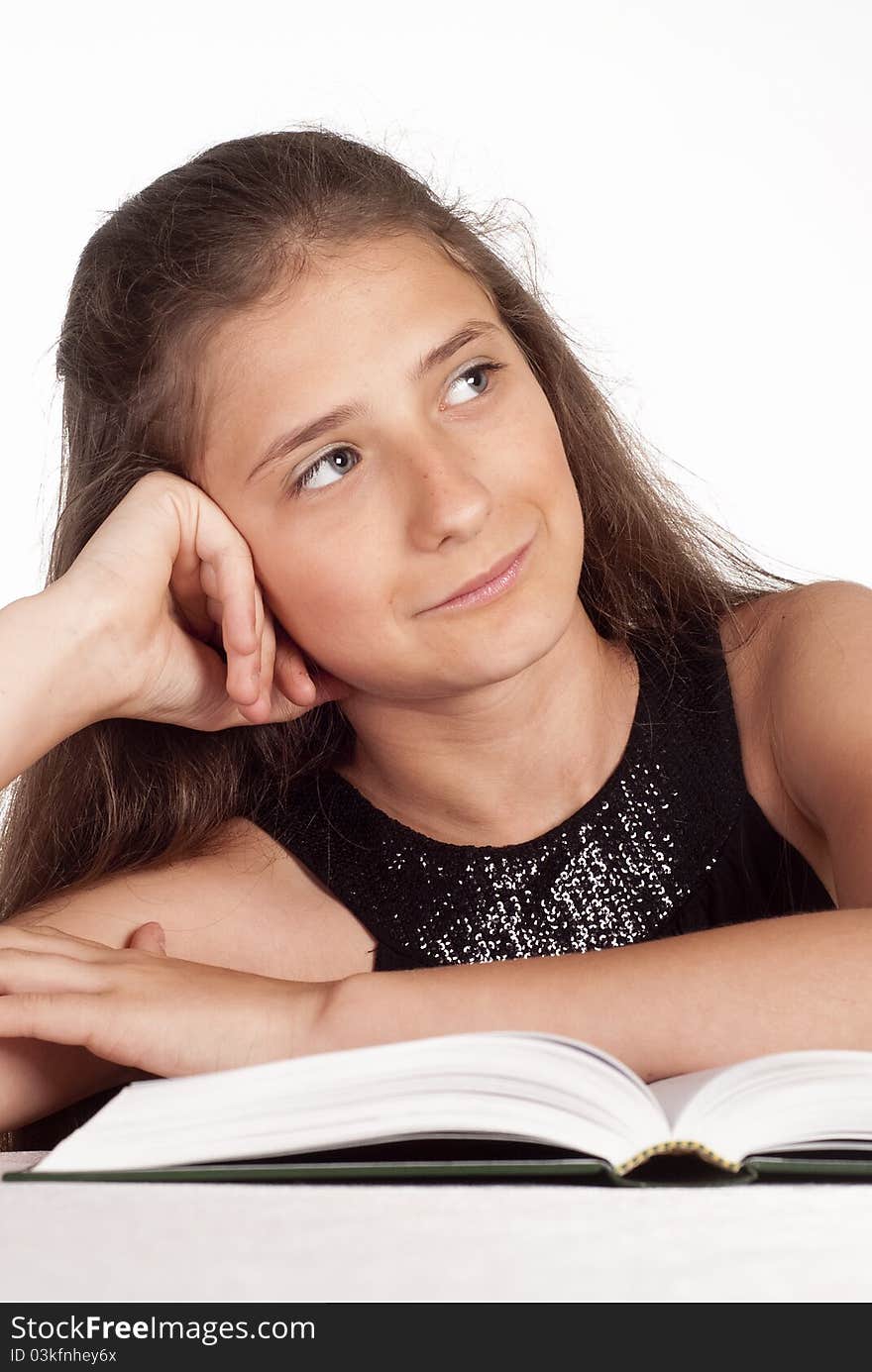 Portrait of a cute young girl reading a book. Portrait of a cute young girl reading a book