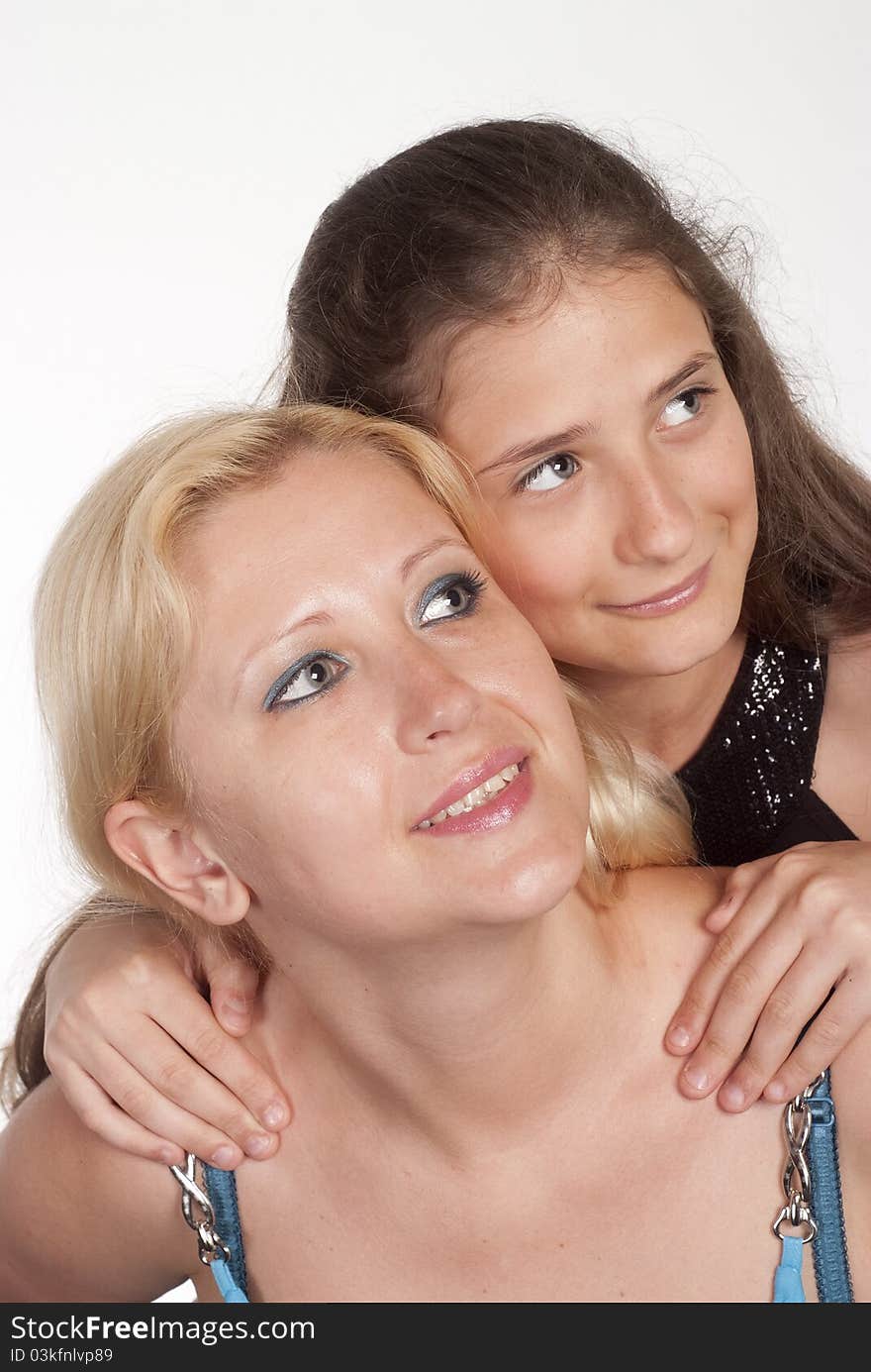 Happy mom and daughter posing on a white. Happy mom and daughter posing on a white