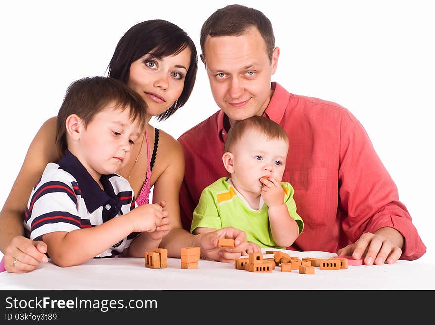 Happy family of a four playing on white. Happy family of a four playing on white