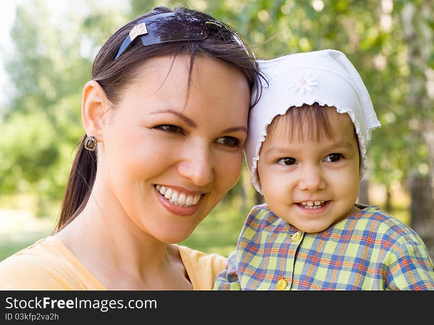 Happy mom and daughter smiling at nature