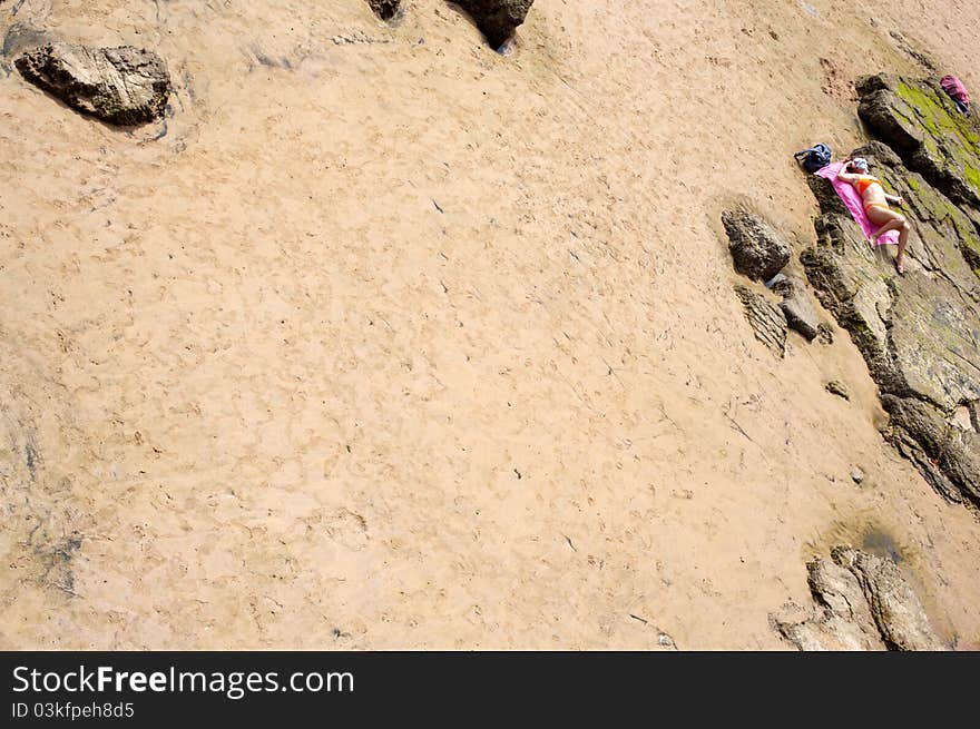 Woman relaxing in the beach of Gijon