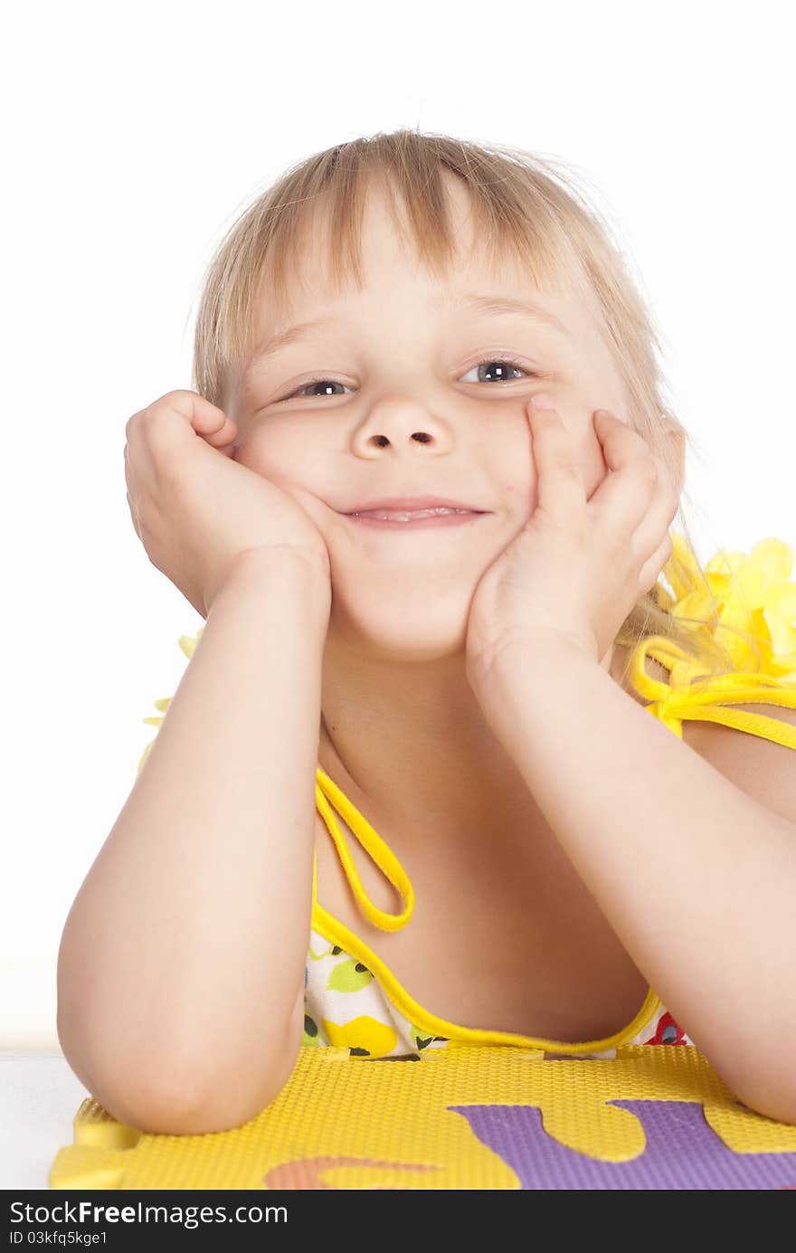 Little girl smiles on a white background