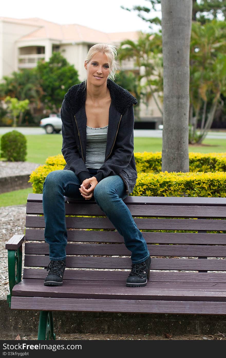 Young attractive woman relax in the park on vertical format