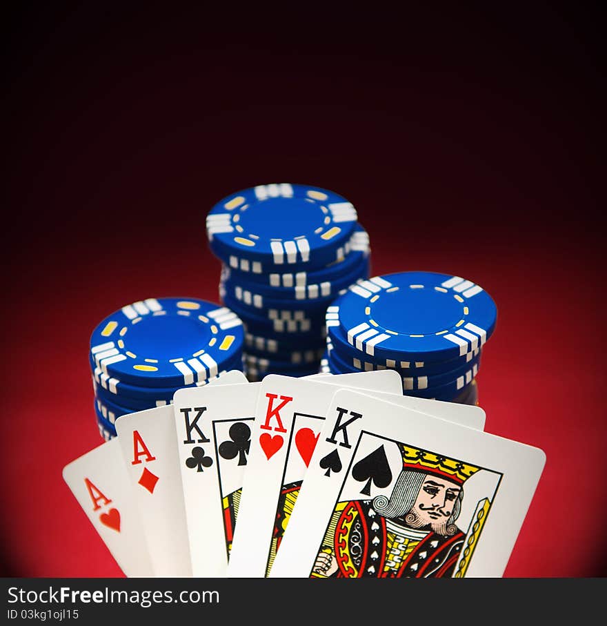 Winning poker hand on red felt with blue chips and room for copy space. Winning poker hand on red felt with blue chips and room for copy space