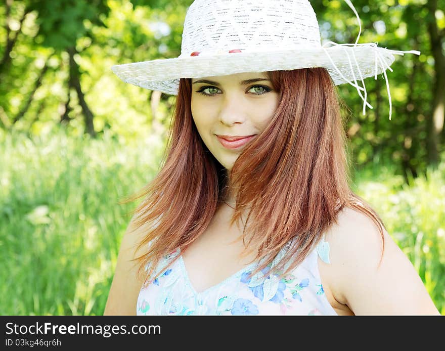 Red-haired beautiful girl in the white hat. Red-haired beautiful girl in the white hat