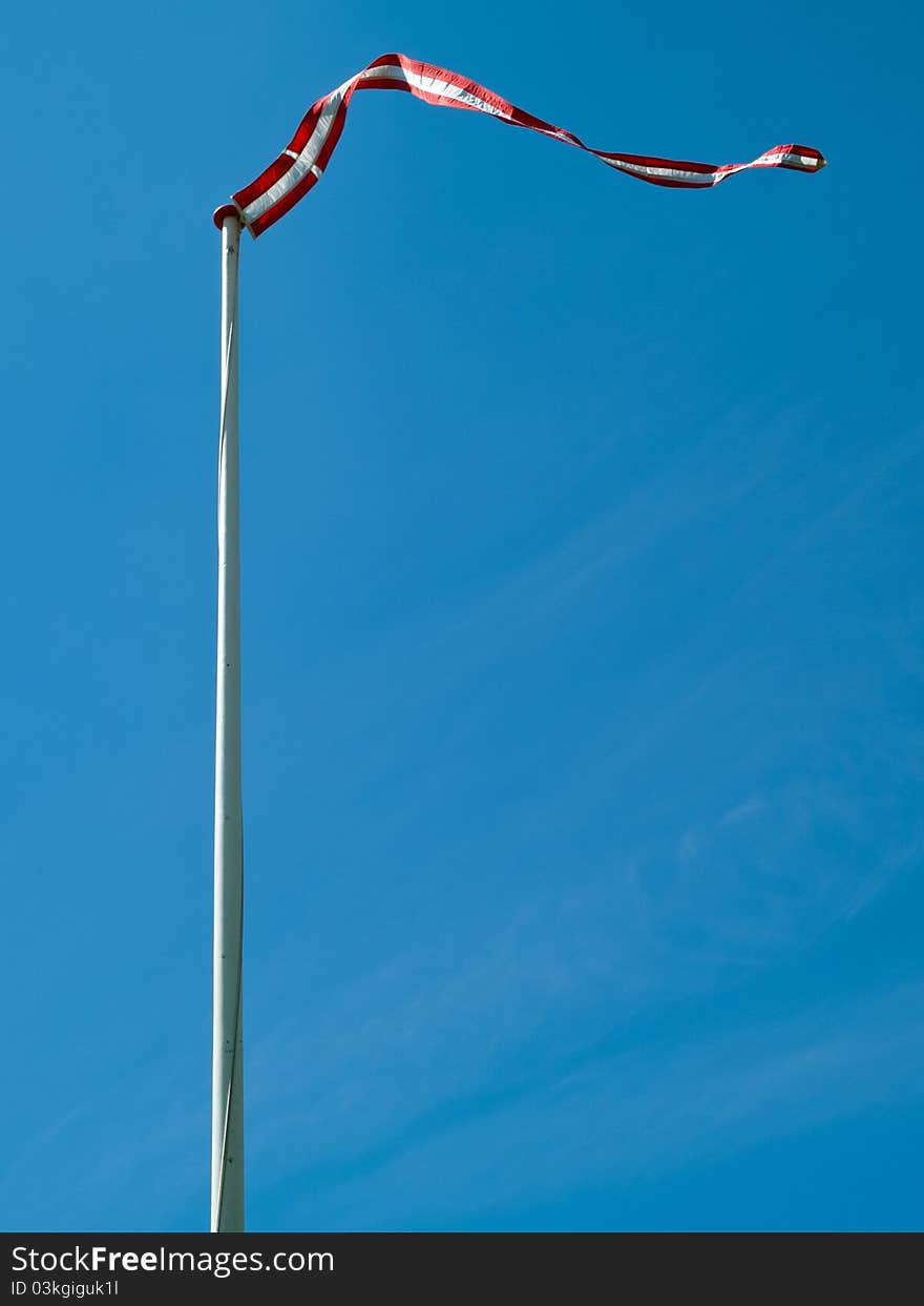 Flag of Denmark up high with clear blue sky background vertical image. Flag of Denmark up high with clear blue sky background vertical image