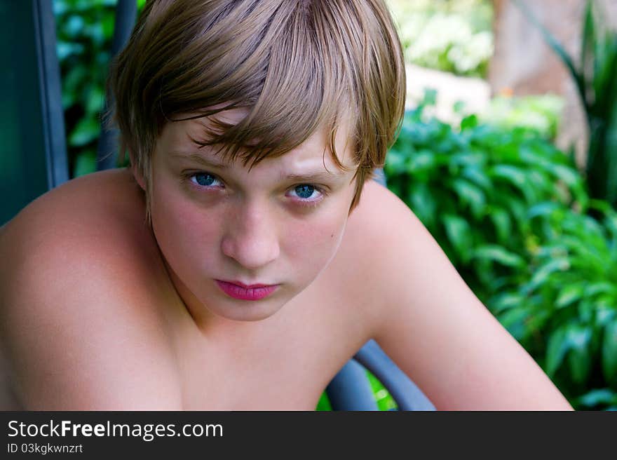 Portrait of teenage boy on the grass background