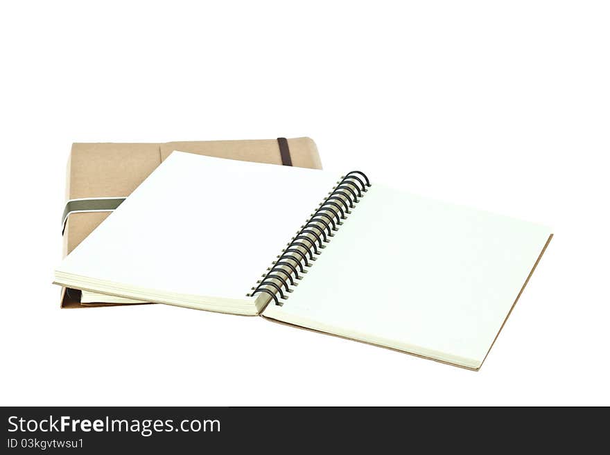 Isolated Light cream color paper note book on brown book. Isolated Light cream color paper note book on brown book