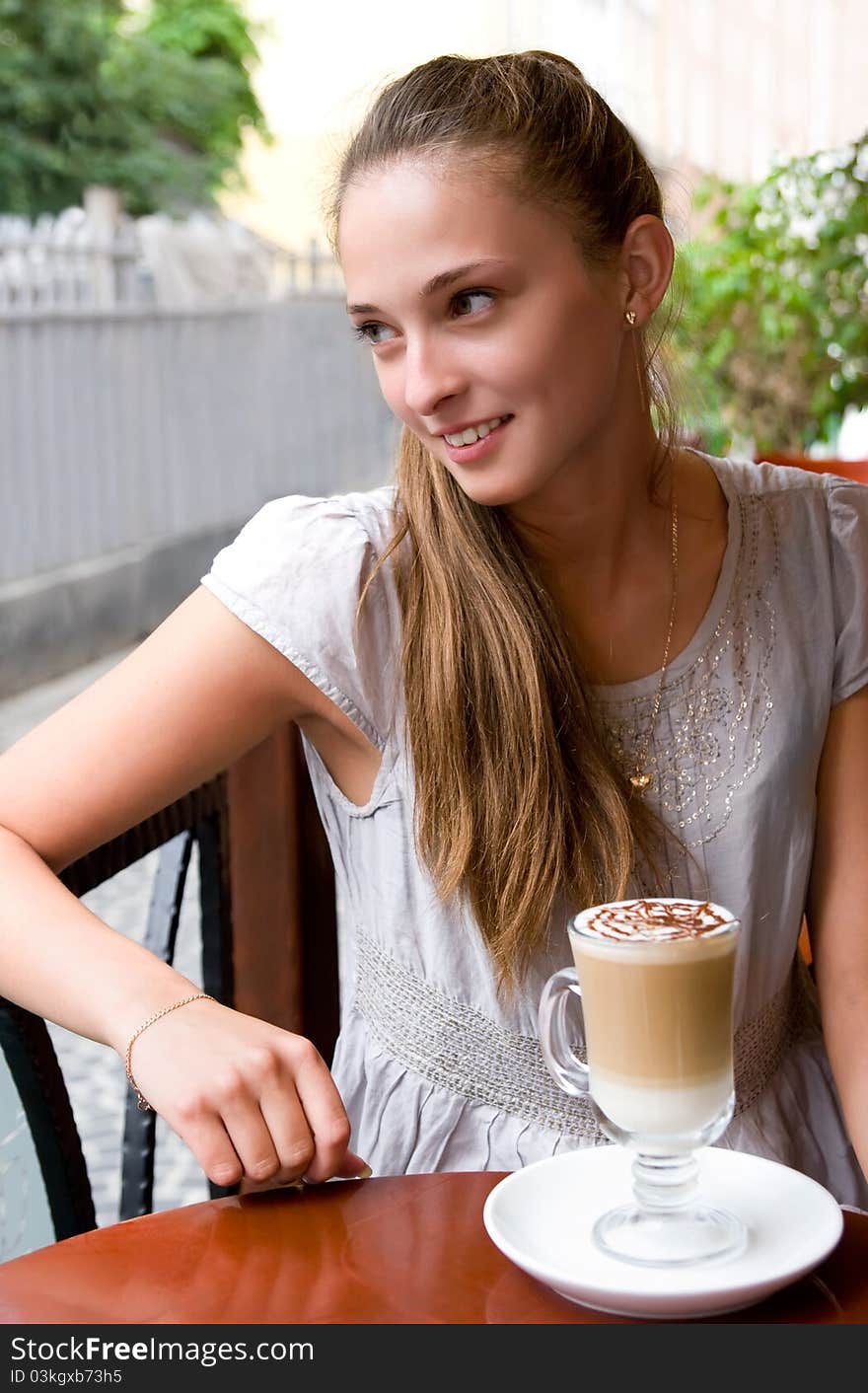 Woman With Coffee In Cafe