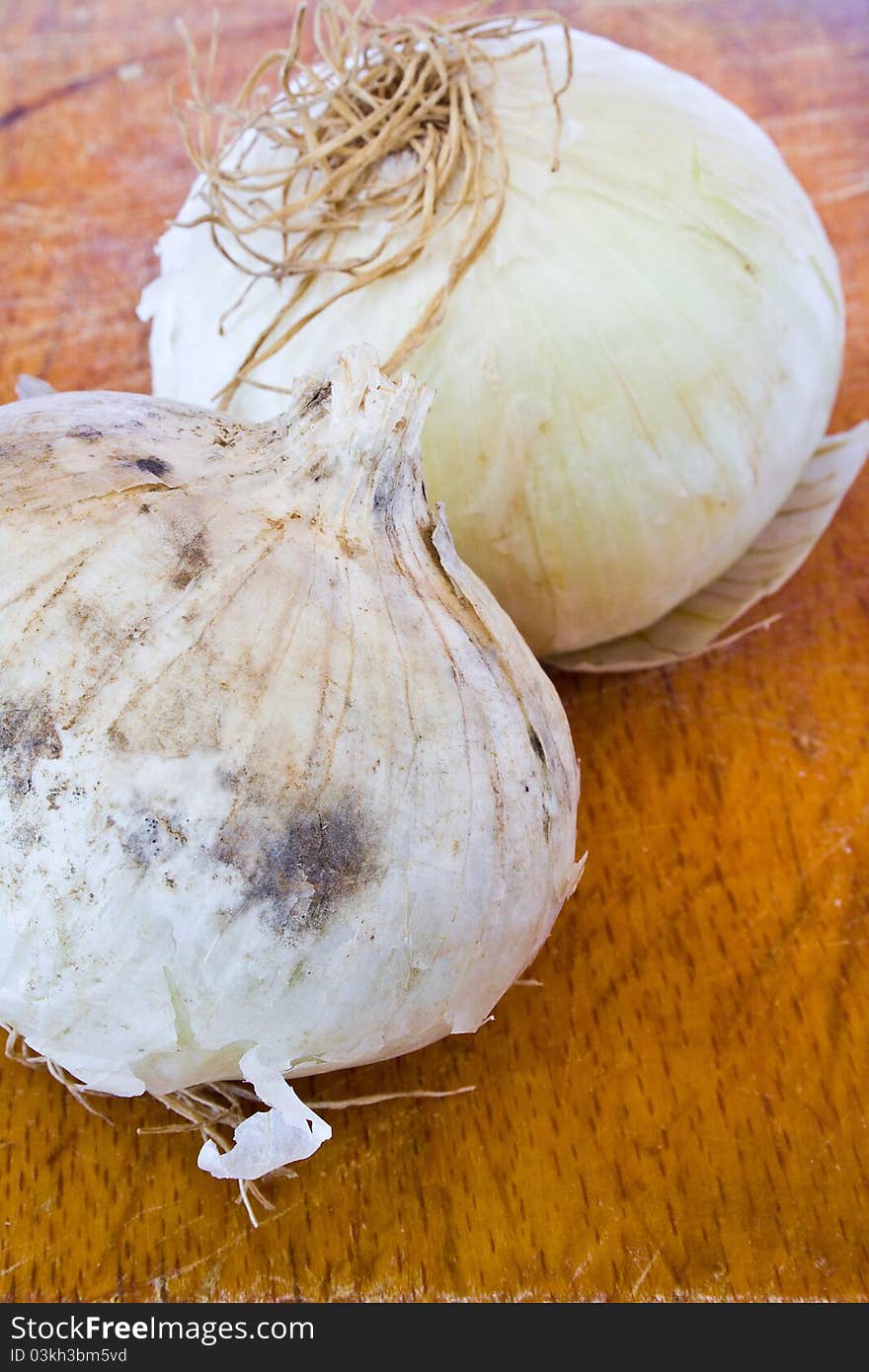 Closeup of two bulbs of onion on the table