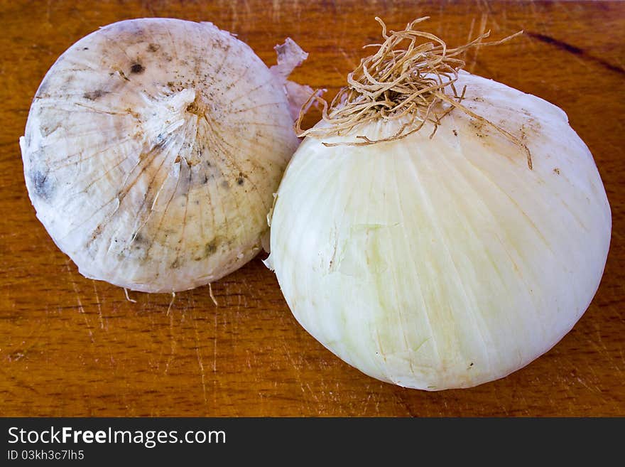 Closeup of two bulbs of onion on the table