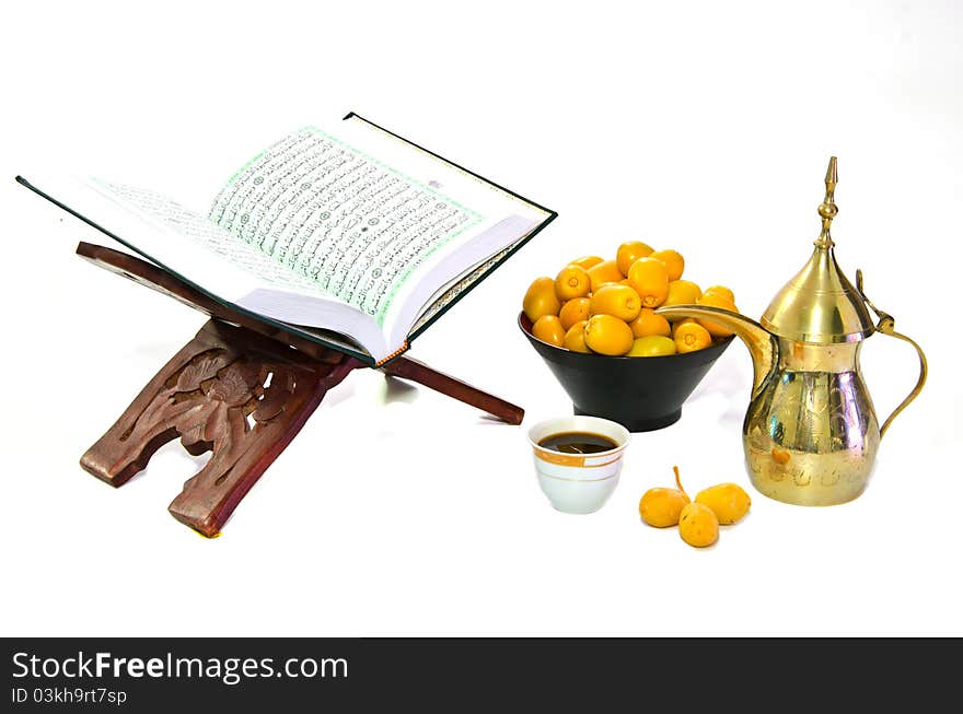 Arabic Coffee with Dates Fruit and the Holy Quran isolated on white Background. Arabic Coffee with Dates Fruit and the Holy Quran isolated on white Background