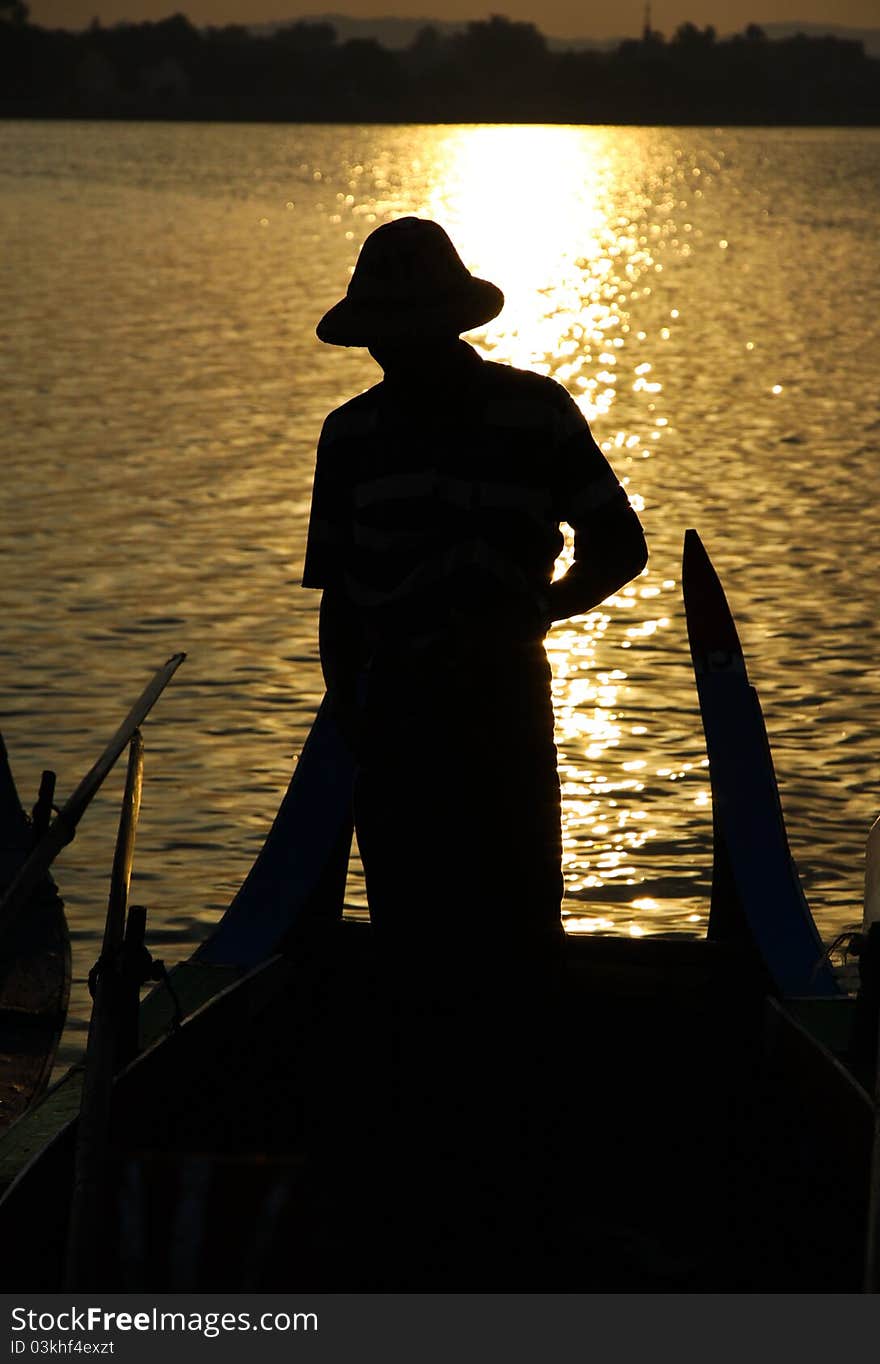 Burmese old man row wooden boat in Myanma