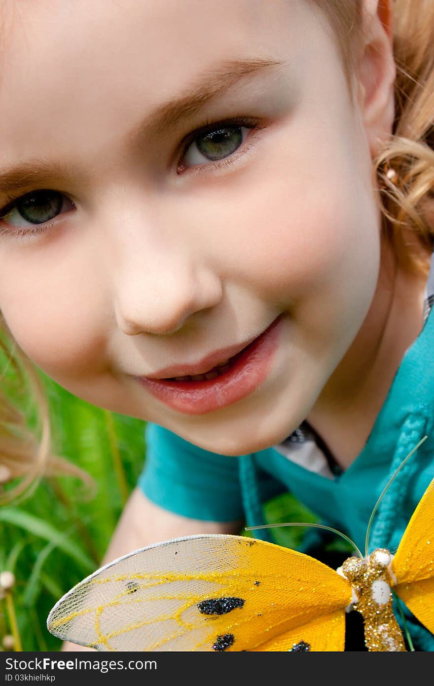 Cute little girl smiling in a park close-up