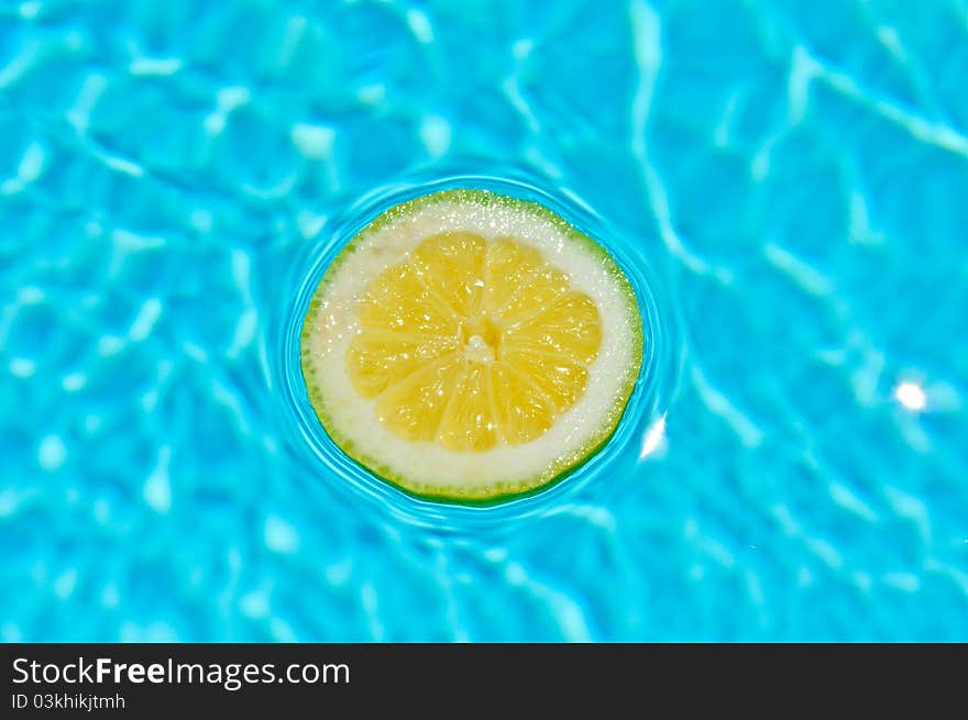 Yellow lemon in a beautiful blue water