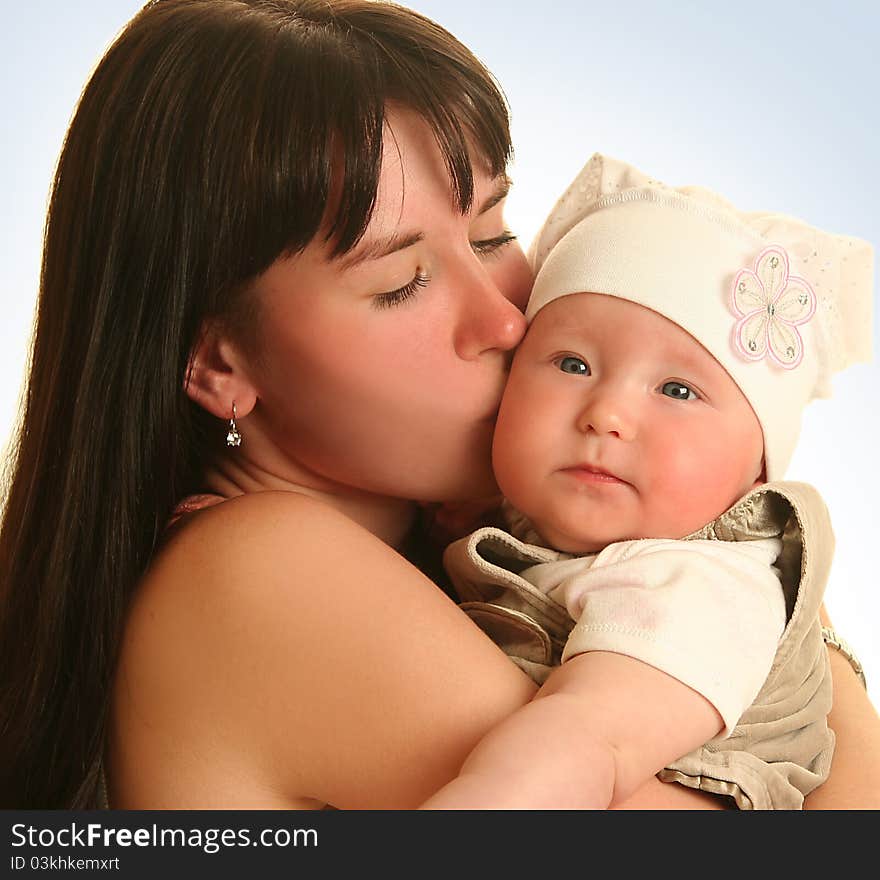 Young mother with baby on blue background. Young mother with baby on blue background