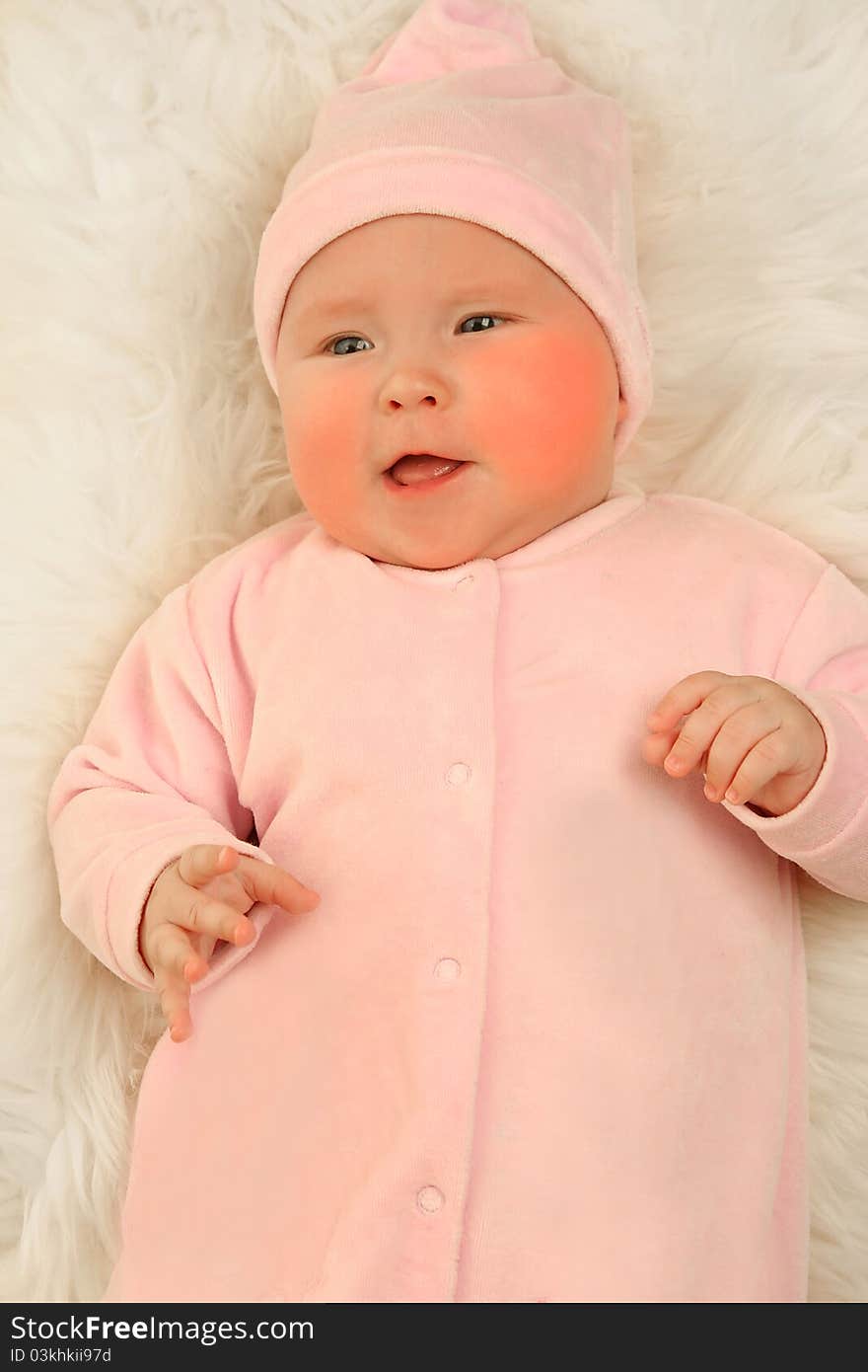 Cute little girl on white fur