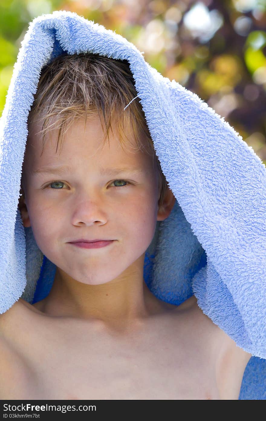 A young child in nature with towel