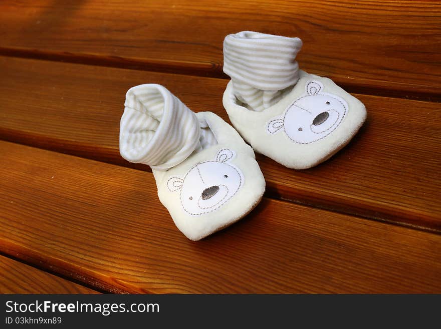 Baby white shoes on wood. Baby white shoes on wood