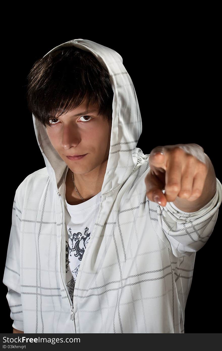 Young stylish man in hood pointing for finger at camera. Young stylish man in hood pointing for finger at camera