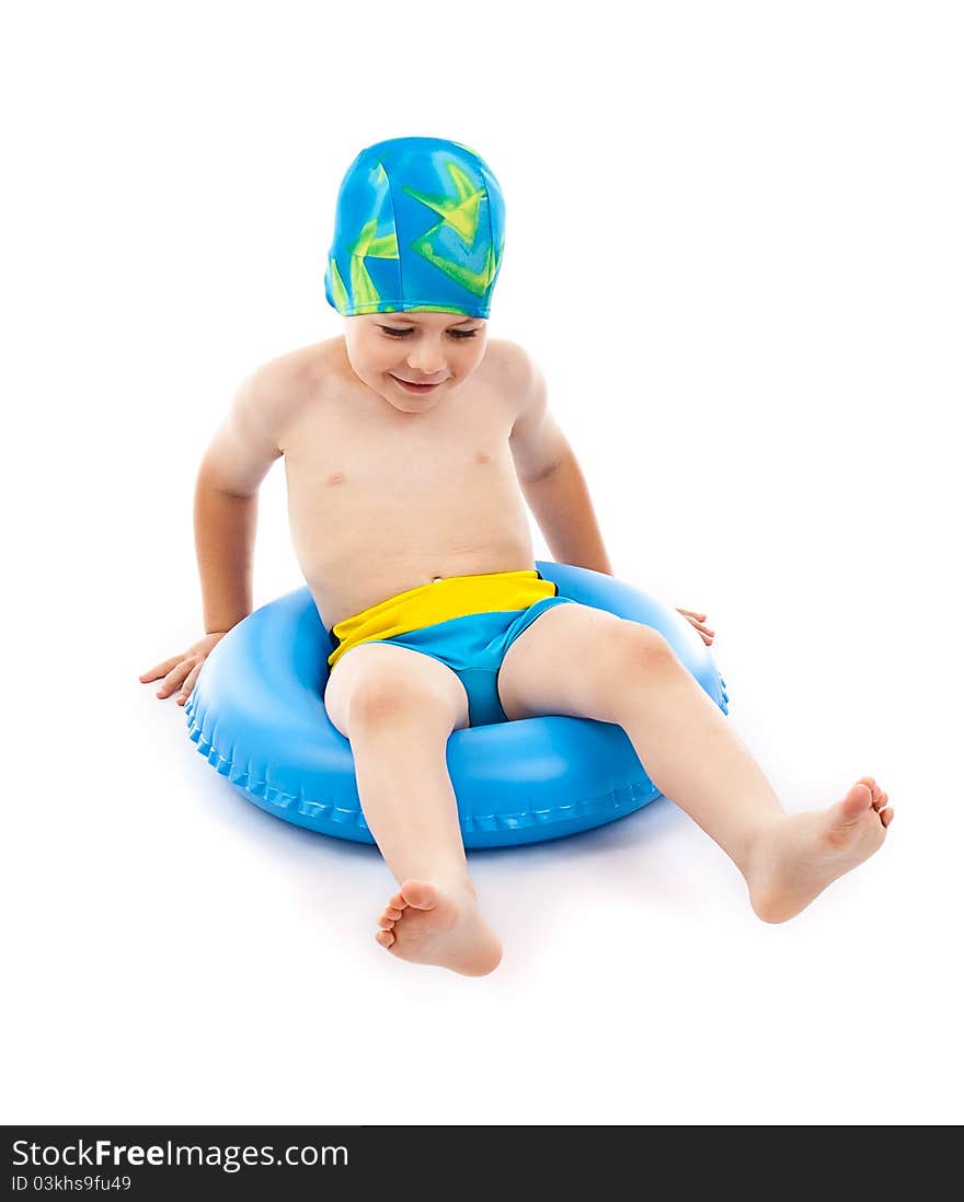 Funny little boy playing with blue life ring in swim caps