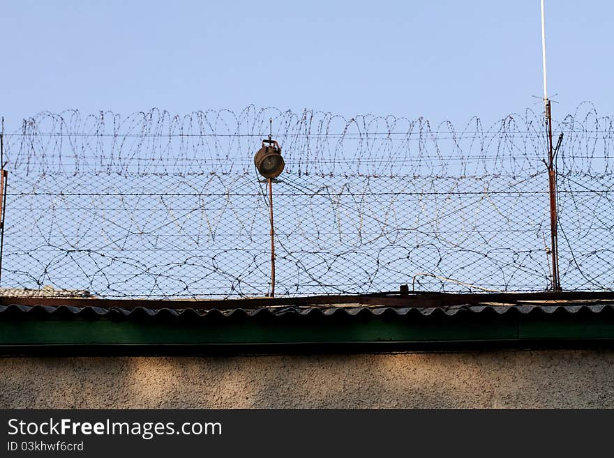 Prison wall and blue sky