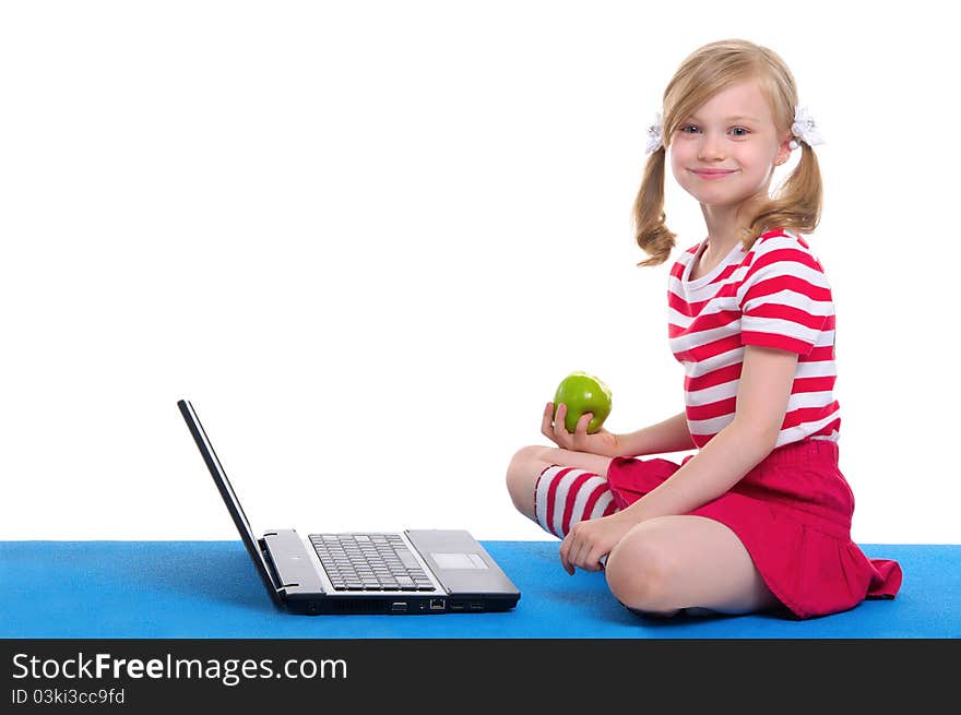 Girl With An Apple And Laptop Sitting On Rug