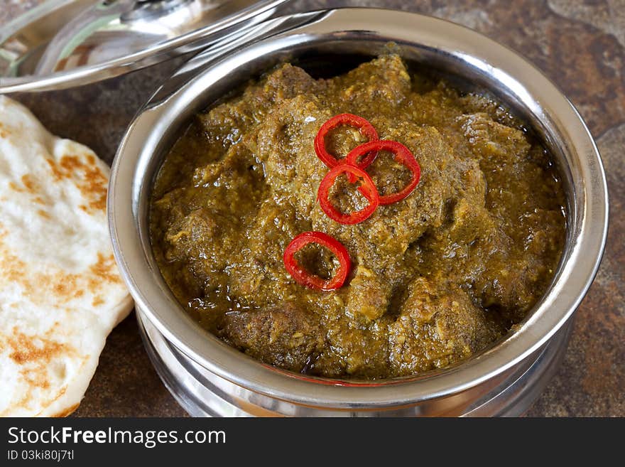 Lamb korma Indian curry in serving bowl, with naan bread. Lamb korma Indian curry in serving bowl, with naan bread.