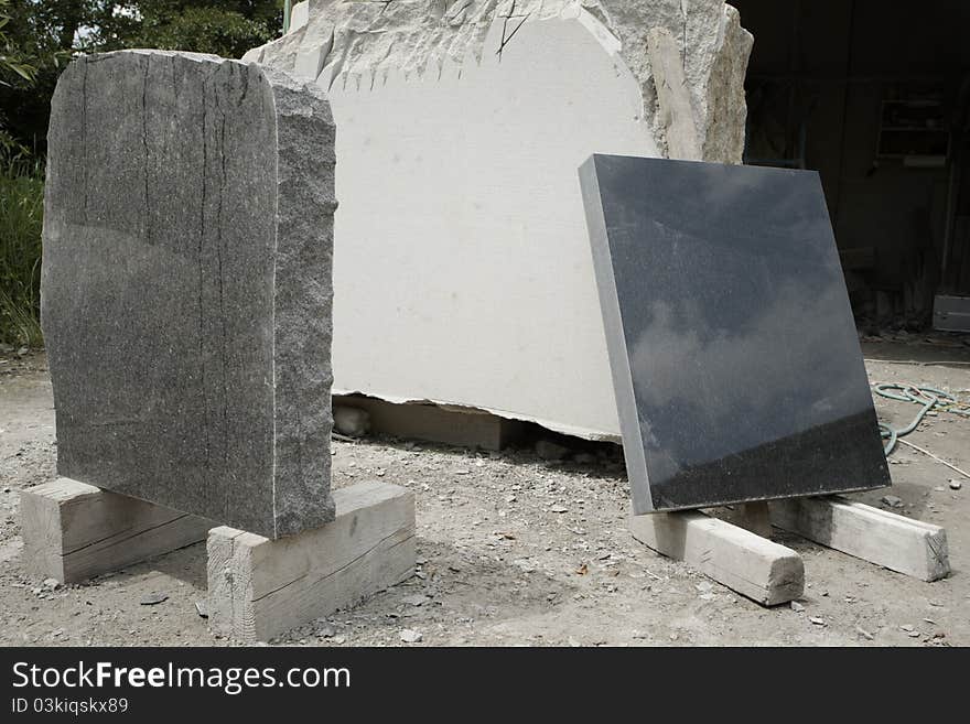 Blank tombstones from granite in workshop.